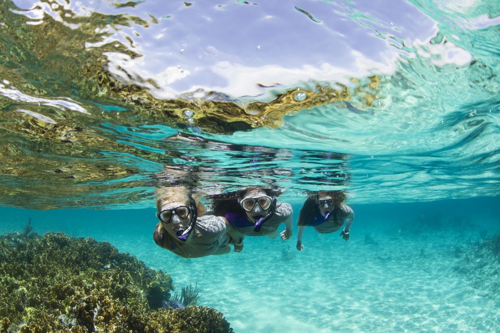 Three girls snorkeling at Aruba